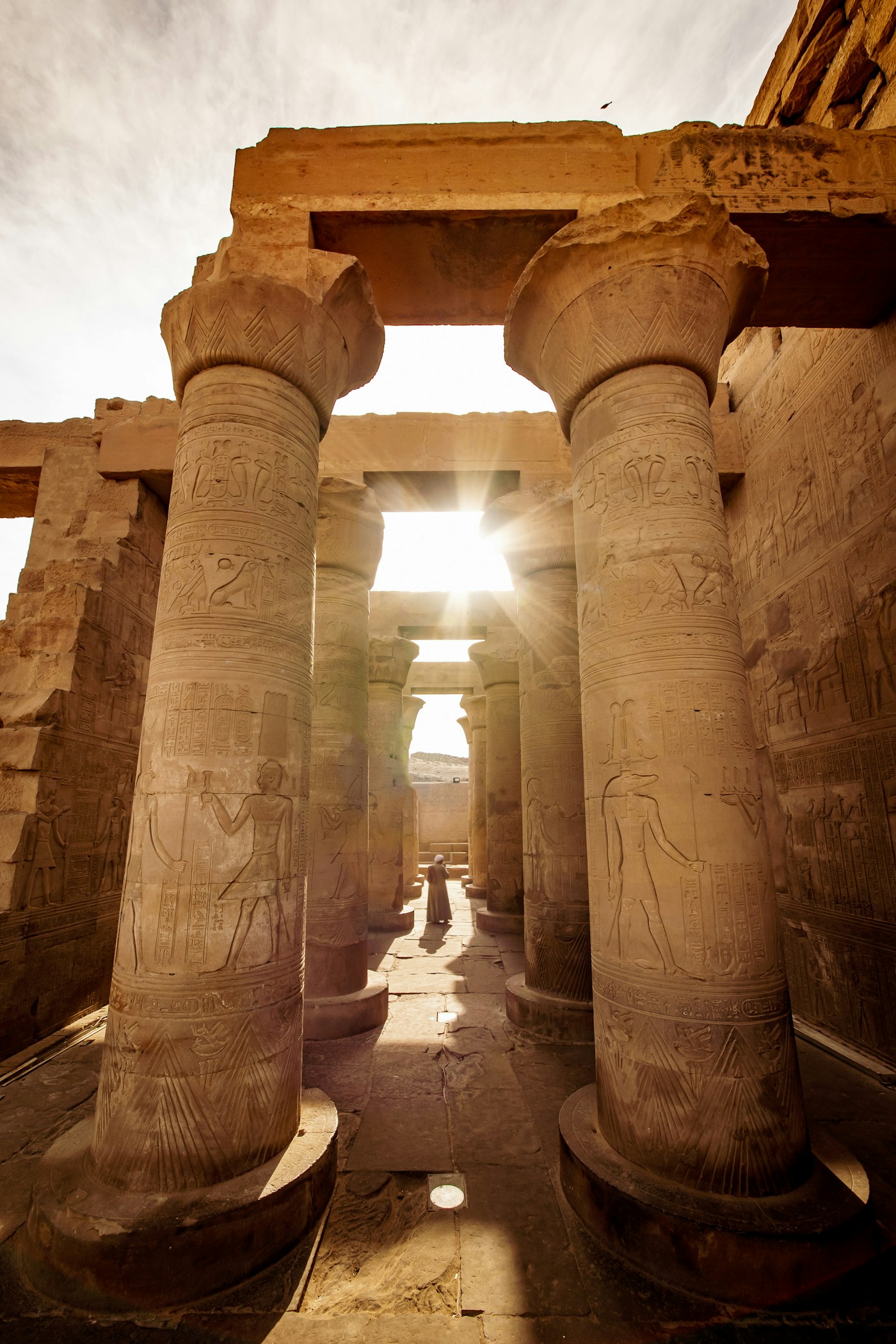 Visitors walking through Karnak Temple colonnade